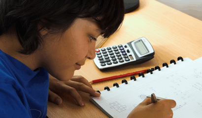 A boy does math homework.